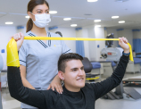 paciente realizando un ejercicio medico mientras lo supervisa la enfermera