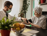 doctor tomando el pulso de senora de edad
