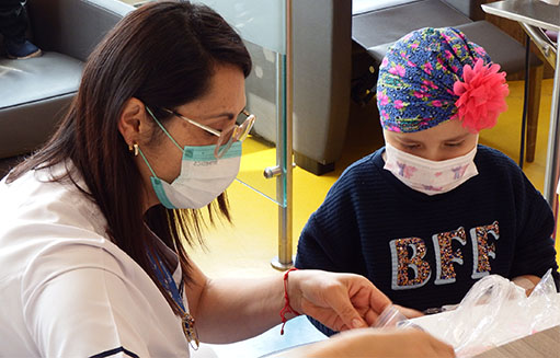 doctora jugando con nina con cancer pediatrico